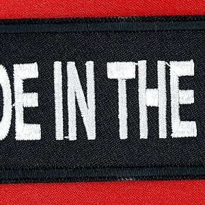 May include: Black fabric patch with white embroidered text that reads "MADE IN THE 60'S".