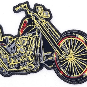 May include: Embroidered patch featuring a black motorcycle with yellow and gray detailing. The motorcycle has a red accent on the front and a yellow spoke wheel with a red rim. The patch is outlined in black.
