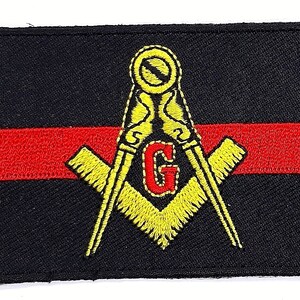 May include: A black and red embroidered patch with a yellow Masonic symbol, including a compass, square, and the letter 'G'.