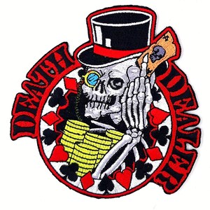 May include: Embroidered patch featuring a skeleton wearing a top hat and monocle, holding a playing card. The design includes stacks of gold coins and a circular frame with playing card suits and the words "DEATH CARD" in red.