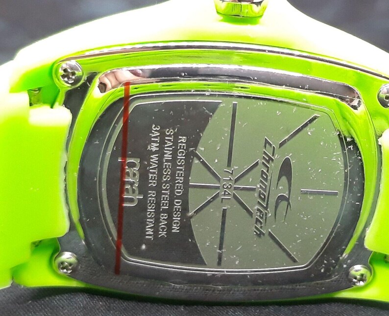 May include: Close-up of the back of a green Chronotech watch with a stainless steel back. The watch is water resistant to 3 ATM. The watch has a registered design.
