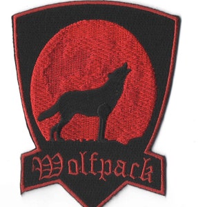 May include: Black embroidered patch with a red moon and a wolf howling at the moon. The text "Wolfpack" is embroidered in red below the moon.