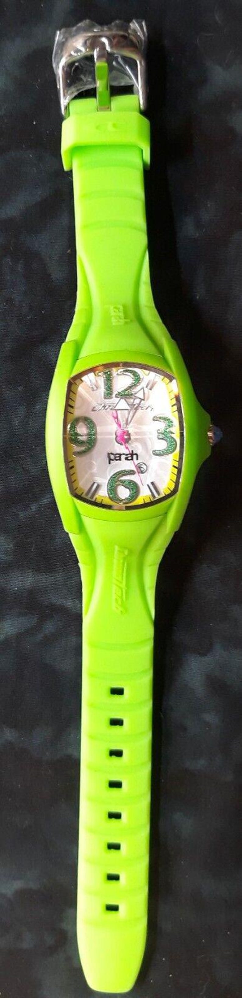 May include: A bright green wristwatch with a white face and black numbers. The watch has a silver buckle and a green band.