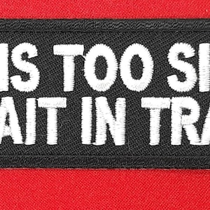 May include: Black embroidered patch with white text that reads "Life is too short to wait in traffic."