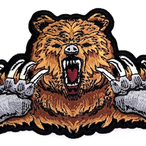 May include: Embroidered patch of a brown bear with its claws out, roaring with its mouth open. The bear is on a black background.