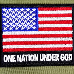 May include: A black and white embroidered patch with an American flag and the text "ONE NATION UNDER GOD".