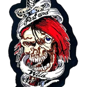 May include: Embroidered patch featuring a skull with red hair, a dagger, and a banner that reads "Fast and Wild".