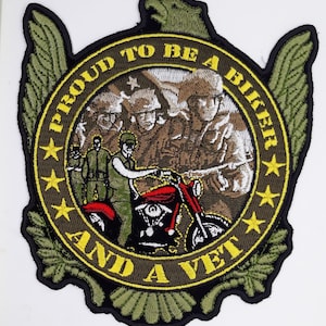 May include: A green, yellow, and black embroidered patch with an eagle, a motorcycle, and the text "Proud to be a biker and a vet".