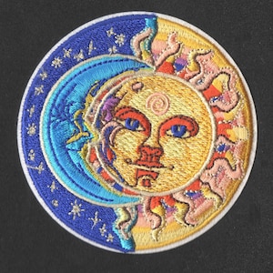May include: Embroidered patch featuring a celestial design with a sun and moon. The sun has a smiling face with blue eyes and a red mouth. The moon is blue with stars. The patch is round with a white border.