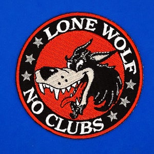 May include: Embroidered patch with a circular design featuring a snarling wolf's head in black and white against a red background. The words "LONE WOLF" and "NO CLUBS" are in white, with stars around the edge. The patch is set against a blue background.