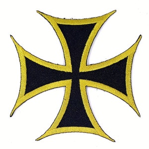 May include: A black iron cross with a yellow outline. The cross is a popular symbol in biker culture.