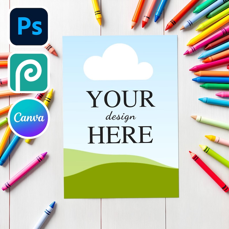 May include: A rectangular card featuring a light blue sky with a white cloud and a green landscape at the bottom, with the black text YOUR design HERE centred. The card is surrounded by numerous colourful wax crayons on a white surface.