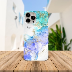 May include: A white phone case with a blue and purple abstract design and gold glitter. The name "Jessica" is printed on the case.