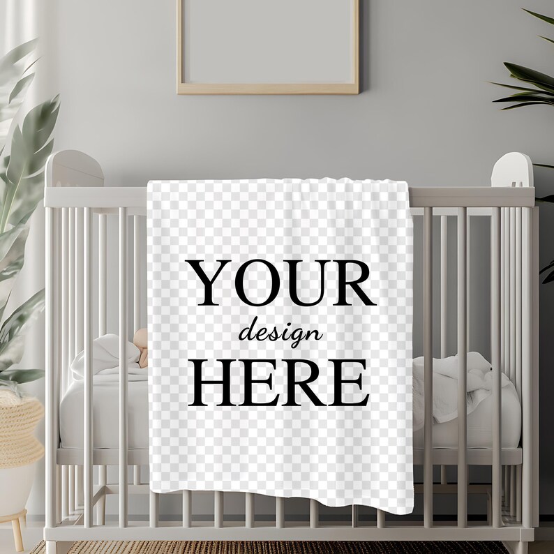 May include: White baby blanket with black text that says "YOUR design HERE" on a white crib.
