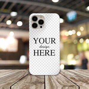 May include: White phone case with a clear back and a black camera bump. The case has the text "YOUR design HERE" printed on the back.