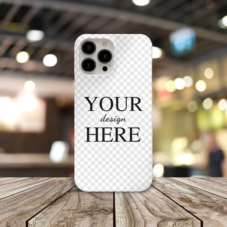 May include: White phone case with a clear back and a black camera bump. The case has the text "YOUR design HERE" printed on the back.