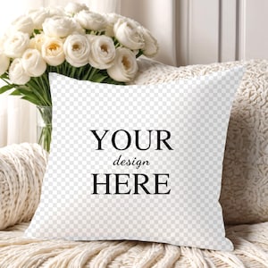 May include: White throw pillow with the text "YOUR design HERE" in black lettering.
