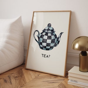 May include: A framed print with a watercolor illustration of a black and white checkered teapot with a blue glaze. The text "TEA?" is written below the teapot.