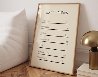 May include: A framed menu with a beige background and black text listing cafe menu items and prices. The menu includes Americano, Espresso, Mocha, Cappuccino, Latte, Matcha Latte, and Croissant. The frame is made of wood and has a light brown finish.