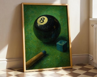 May include: Framed artwork featuring a black eight ball with a yellow number 8, a blue chalk cube, and a pool cue on a green felt surface. The artwork is in a wooden frame and is displayed indoors.