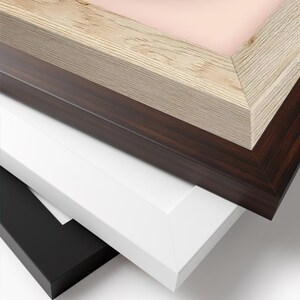 May include: A stack of picture frames in various colors and finishes. The frames include a light wood grain, dark brown wood grain, white, and black. The frames are angled, showcasing their different textures and colors.