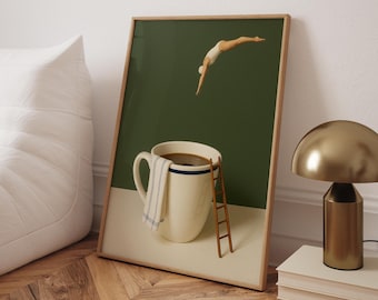 May include: A framed art print depicts a whimsical scene of a person diving into a coffee-filled mug. The mug has a blue stripe and a small ladder. A towel hangs on the side. The background is green and white.