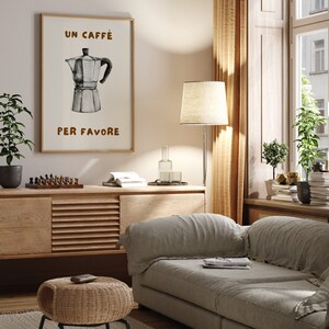 May include: A framed print with a watercolor illustration of a coffee pot and the text "Un Caffe Per Favore" in brown lettering.