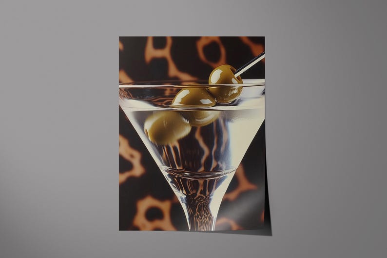 May include: A martini glass filled with a clear liquid and garnished with two green olives on a toothpick. The glass is sitting on a brown and black patterned surface.