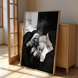 May include: Black and white framed print featuring four nuns smoking cigarettes. The nuns are wearing traditional habits and veils. The background is a mix of black and white.