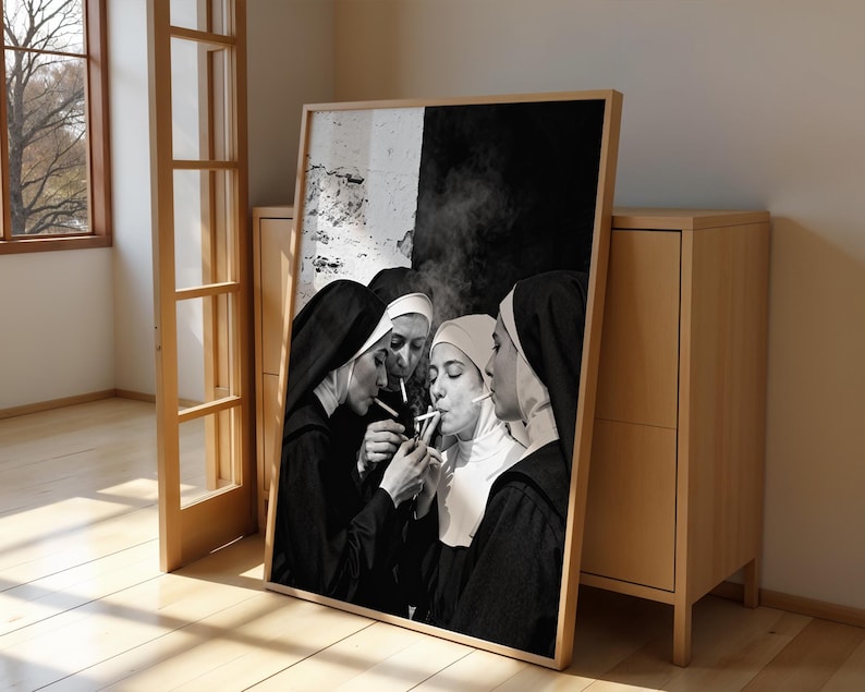 May include: Black and white framed print featuring four nuns smoking cigarettes. The nuns are wearing traditional habits and veils. The background is a mix of black and white.