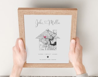 May include: A framed print with a black and white map of a city in the shape of a house. The text "Jake & Millie" is at the top of the print. A red heart is in the center of the map. The text "Home Sweet Home" is below the map. The address "87 Ashcroft Road, Fareham" is below the text.
