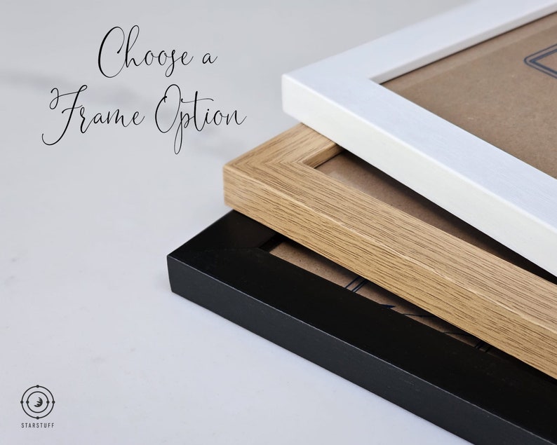 May include: Three picture frames stacked on top of each other. The top frame is white, the middle frame is light brown wood, and the bottom frame is black.