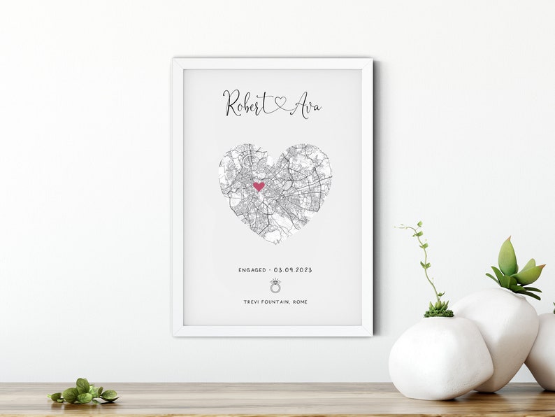 mdf wrapped white photo frame with a black and white map of where the couples special ocassion took place (engaged or married). Their names in a swirly text at the top and underneath the photo is the special occasion date and location written