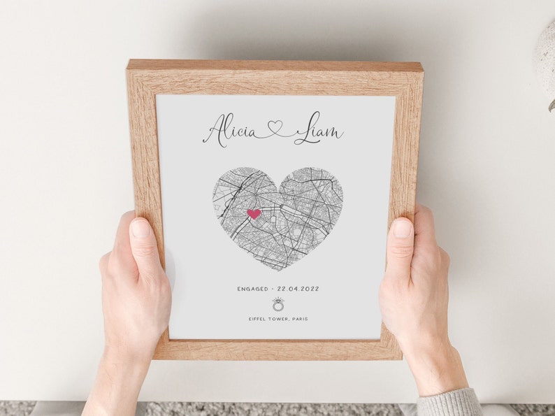mdf wrapped oak photo frame with a black and white map of where the couples special ocassion took place (engaged or married). Their names in a swirly text at the top and underneath the photo is the special occasion date and location written