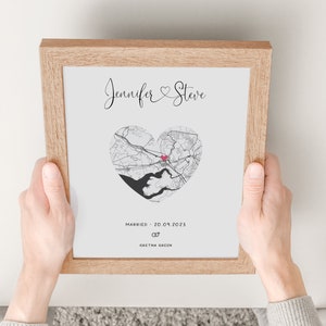 mdf wrapped oak effect photo frame with a black and white map of where the couples special ocassion took place (engaged or married). Their names in a swirly text at the top and underneath the photo is the special occasion date and location written