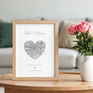 mdf wrapped oak effect frame with a black and white map of where the couples special ocassion took place (engaged or married). Their names in a swirly text at the top and underneath the photo is the special occasion date and location written