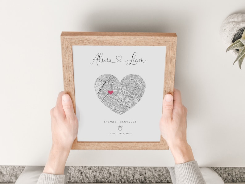 mdf wrapped oak effect photo frame with a black and white map of where the couples special ocassion took place (engaged or married). Their names in a swirly text at the top and underneath the photo is the special occasion date and location written