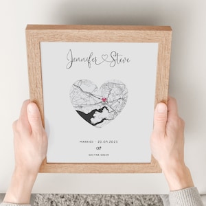 mdf wrapped oak photo frame with a black and white map of where the couples special ocassion took place (engaged or married). Their names in a swirly text at the top and underneath the photo is the special occasion date and location written