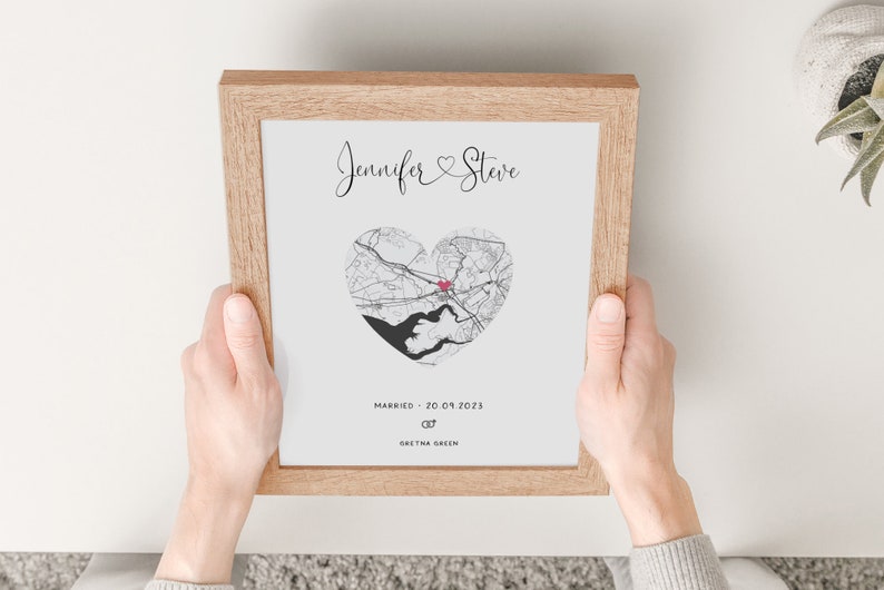 mdf wrapped oak photo frame with a black and white map of where the couples special ocassion took place (engaged or married). Their names in a swirly text at the top and underneath the photo is the special occasion date and location written