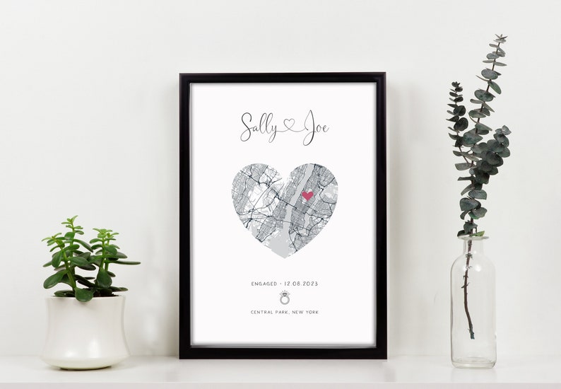 mdf wrapped black photo frame with a black and white map of where the couples special ocassion took place (engaged or married). Their names in a swirly text at the top and underneath the photo is the special occasion date and location written