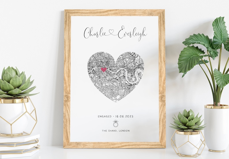 mdf wrapped oak photo frame with a black and white map of where the couples special ocassion took place (engaged or married). Their names in a swirly text at the top and underneath the photo is the special occasion date and location written