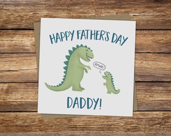 May include: A white card with a blue and green dinosaur illustration. The card says "Happy Father's Day Daddy!" with a speech bubble saying "Rawr!"