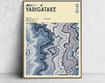 May include: A framed print featuring a topographical map of Yarigatake, with text in English and Japanese. The map uses shades of blue, gray, and pink to depict the mountain's contours. The print is in a neutral-toned frame.
