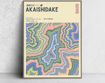 May include: A framed art print featuring a colorful abstract topographical map of Mount Akaishi in Japan. The artwork displays a series of layered, wavy lines in shades of blue, green, pink, and yellow. Text at the top reads "AKAISHIDAKE".