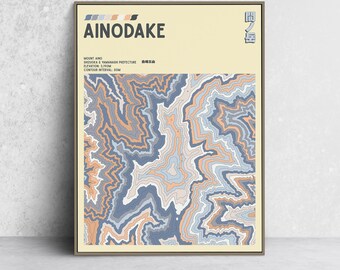 May include: A framed art print featuring a topographic map of Mount Ainodake. The artwork uses a palette of blue, orange, and gray to depict the mountain's contours. The title "AINODAKE" is displayed prominently at the top, with additional text below.
