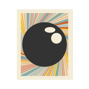 May include: A retro-style print featuring a black bowling ball with two finger holes. The background has colorful, radiating lines in shades of orange, yellow, blue, and pink, set against a cream-colored backdrop. The design evokes a vintage aesthetic.