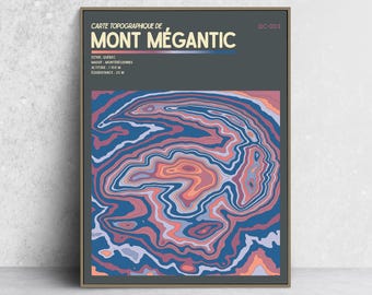 May include: A framed topographic map print of Mont Mégantic, Quebec, featuring a dark gray header with white text and a colorful abstract contour line pattern in shades of blue, purple, and orange. The text includes altitude 1105 M and QC-003.