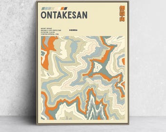 May include: A framed art print featuring a topographic map of Mount Ontake in Nagano & Gifu Prefecture. The map uses a palette of orange, blue, and cream colors. Text at the top reads "ONTAKESAN". Additional text provides elevation and contour interval details.