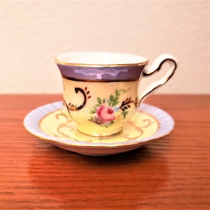 Finest Porcelain Past Times Handpainted Yellow and Lavender Floral Cup And Saucer With Gold Trim And Accents