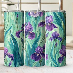 May include: A set of three stainless steel tumblers with a watercolor design of purple irises and green leaves against a teal background. Each tumbler has a silver lid and a white straw.